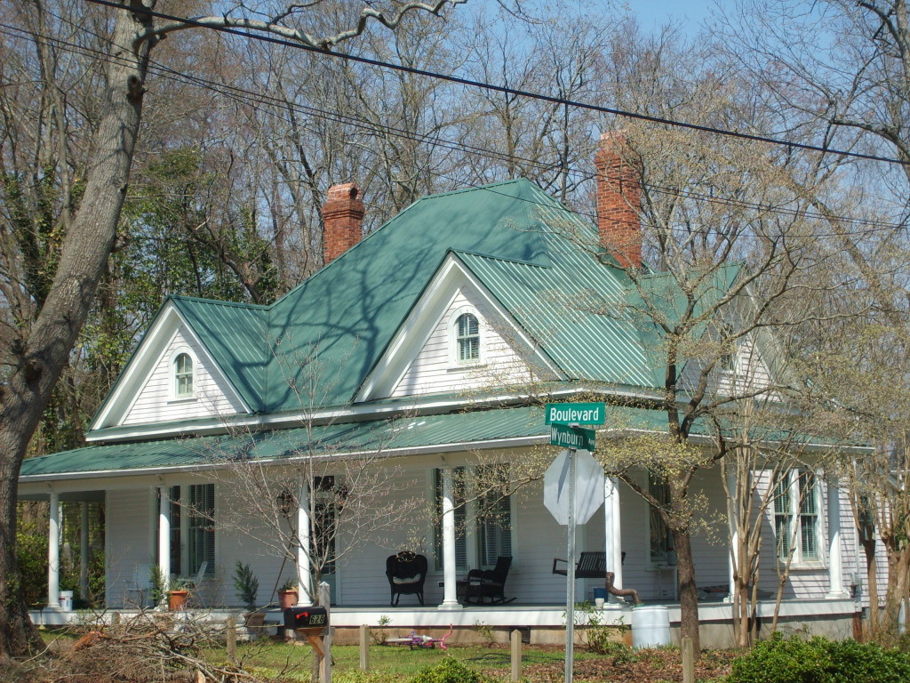 Traditional southern style home with wraparound porch and tin roof